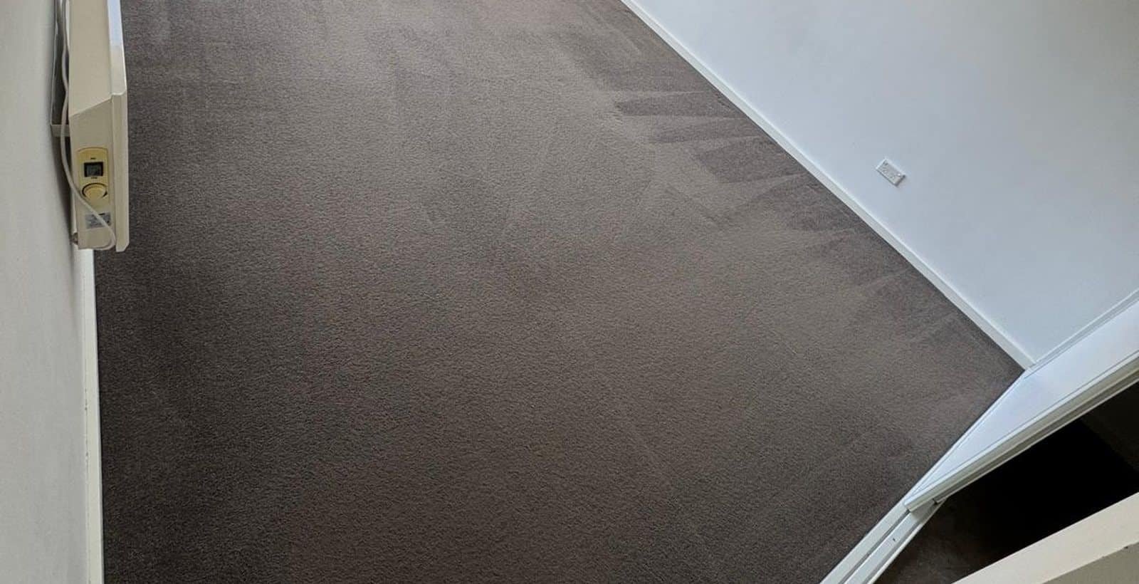 Empty bedroom with freshly cleaned carpet ready for an end of lease inspection