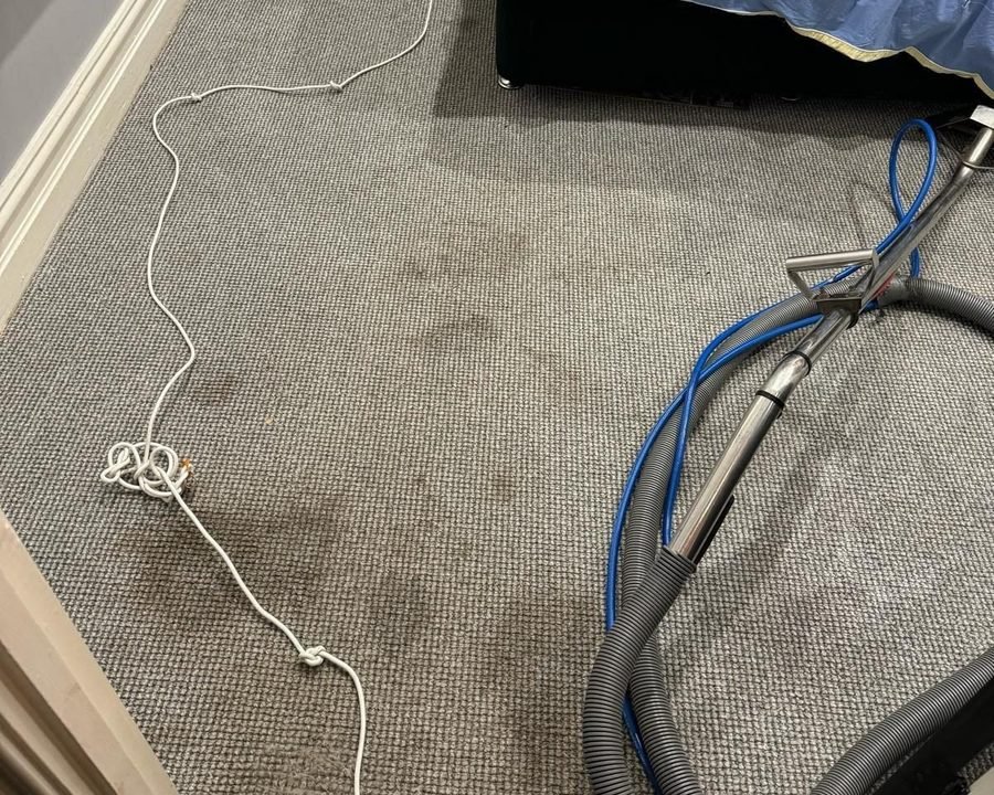 Extraction wand pulling water out of wet carpet in a Melbourne home