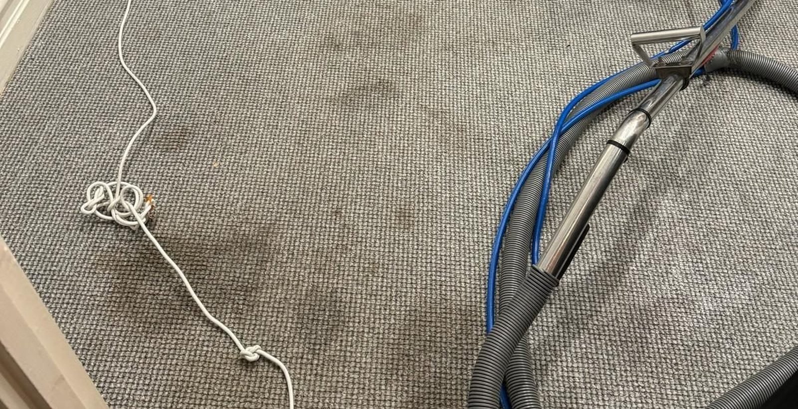 Extraction wand pulling water out of wet carpet in a Melbourne home