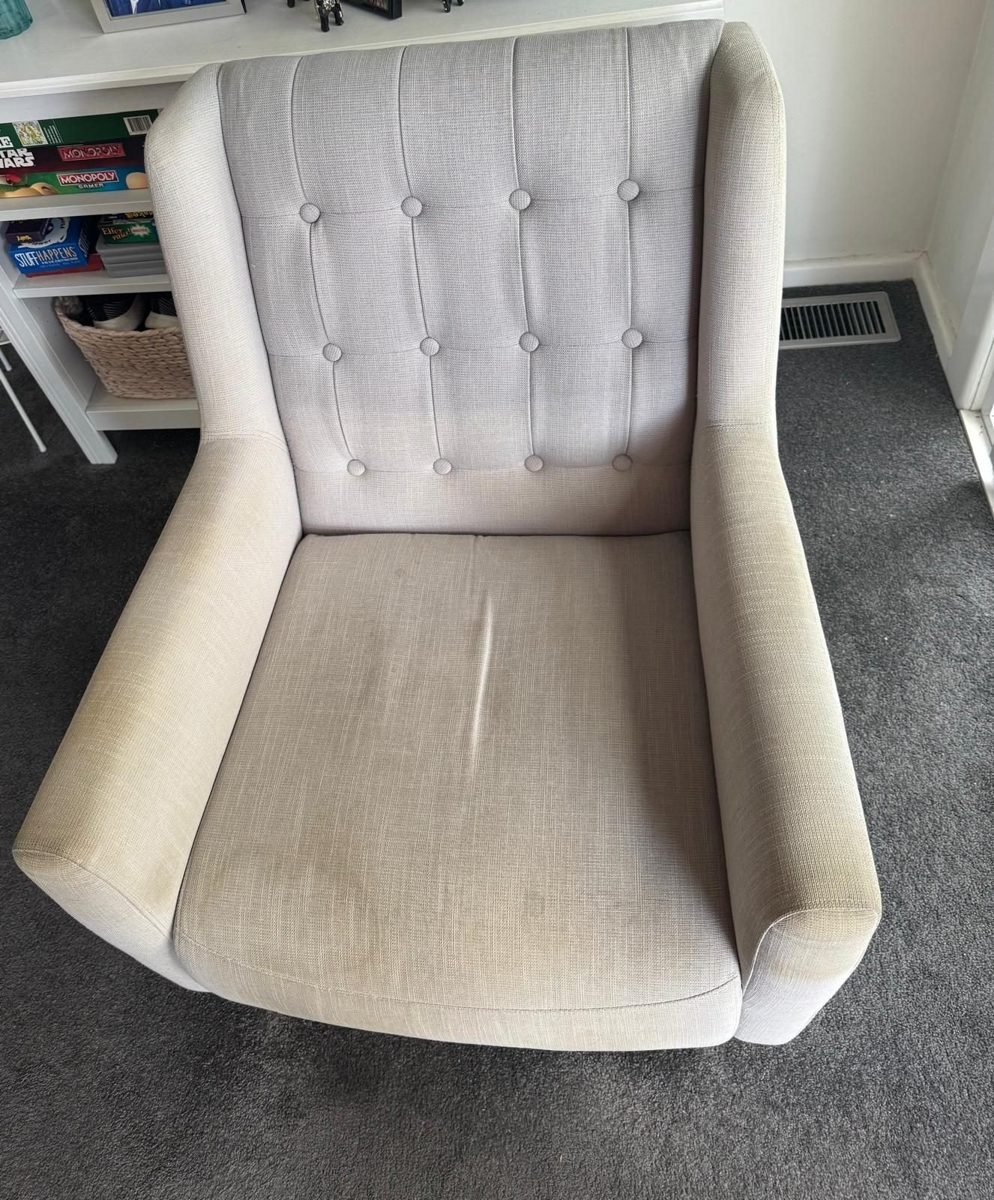 Cream buttoned wingback armchair after upholstery cleaning